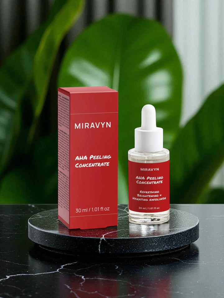 Miravyn AHA Peeling Concentrate bottle  used for acne spot treatment on a black surface with green leaves.