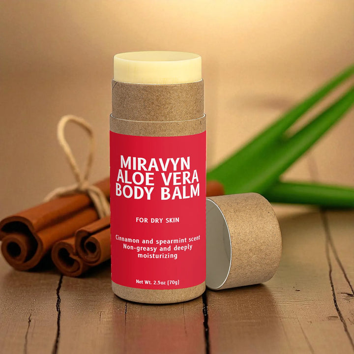Miravyn Aloe Vera Body Balm container on a wooden surface with cinnamon sticks and aloe vera in the background.