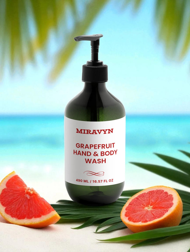 Miravyn Grapefruit Hand & Body Wash bottle with grapefruit slices and leaves on a beach background.