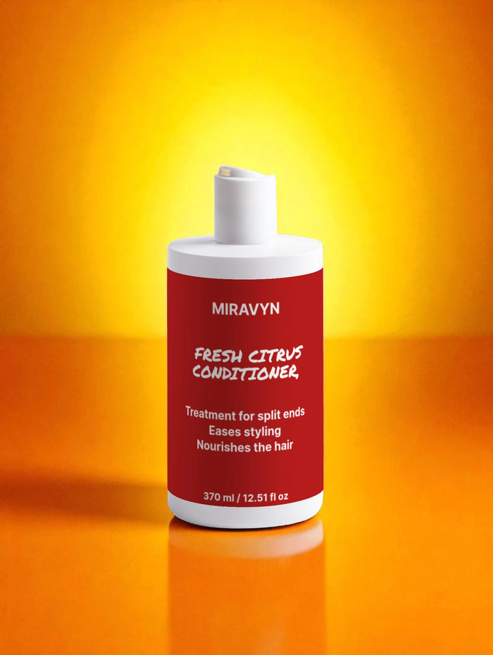 Miravyn Fresh Citrus Conditioner bottle on a reflective orange surface with a yellow gradient background.
