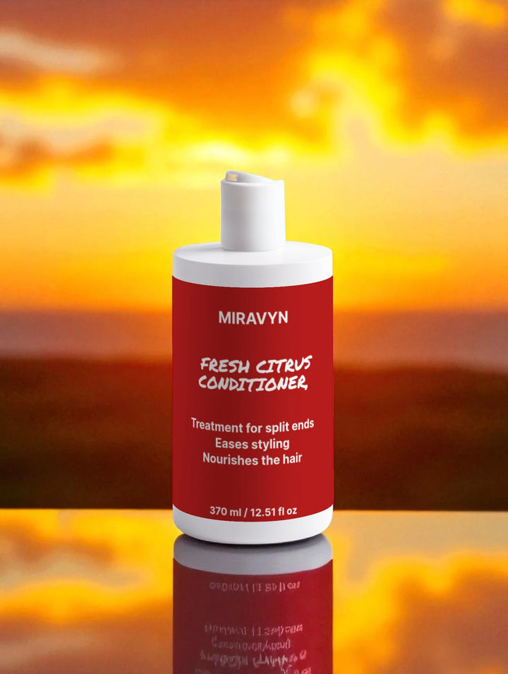 Red and white bottle of Miravyn Fresh Citrus Conditioner against a fiery background.