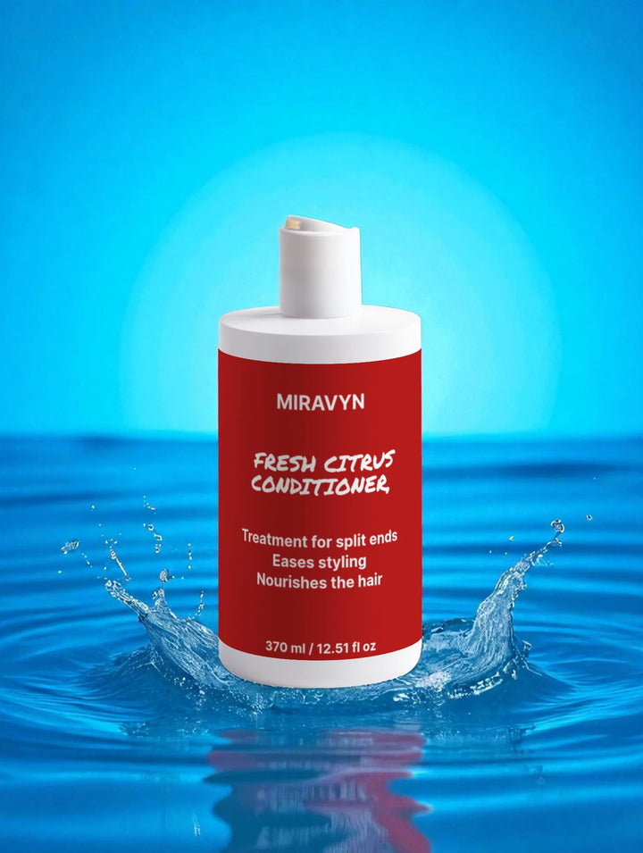 Miravyn Fresh Citrus Conditioner bottle with water splash on a blue background.
