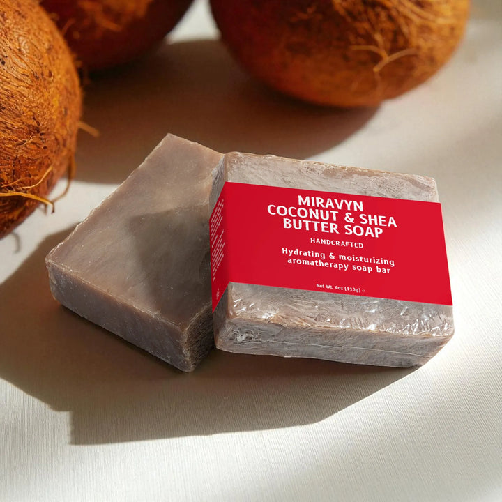 Bar of Miravyn Coconut & Shea Butter Soap with a red label on a light background with coconuts.
