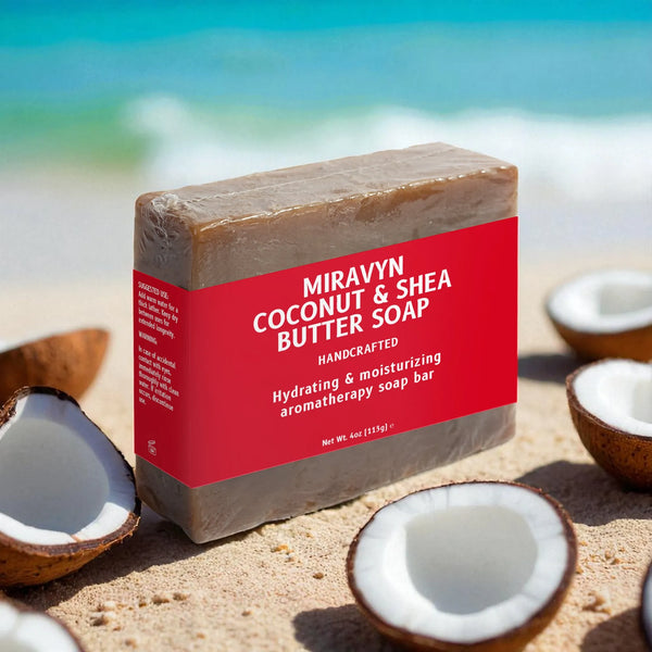 Miravyn Coconut & Shea Butter Soap bar with red label on sand with coconuts.