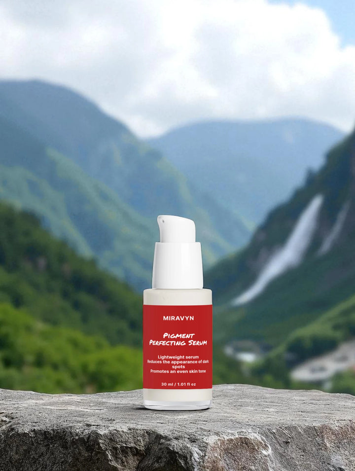Miravyn's dark spot correcting glow serum with a waterfall in the background.