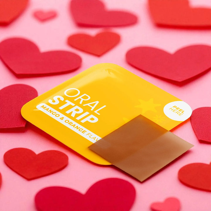 Oral Hangover strips packaging with 'Mango & Orange' flavor on a pink background with red heart shapes.