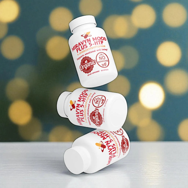 Three Miravin Mood Plus 5-HTP bottles stacked on a reflective surface with a blurred bokeh background.