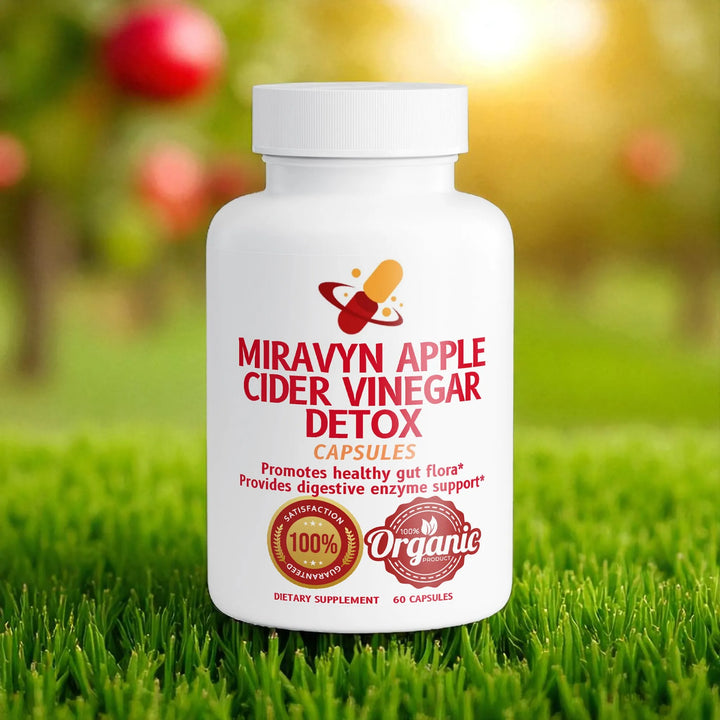 Miravyn Organic Apple Cider Vinegar Detox supplement bottle on grass with apple trees in the background.