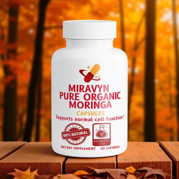 Miravyn Pure Organic Moringa capsules bottle on a wooden surface with an autumn background.
