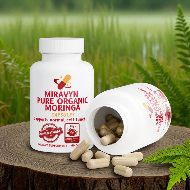 Miravyn Pure Organic Moringa capsules on a wooden surface with a natural background.