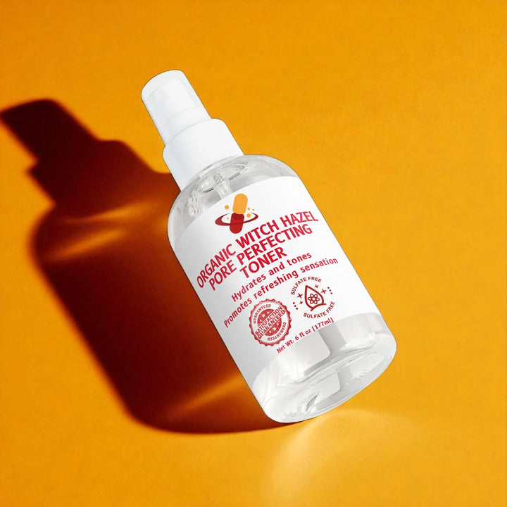 Bottle of Organic Witch Hazel Pore Minimizer Toner sitting flat on orange background.