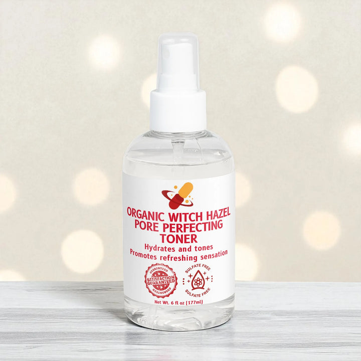 Bottle of Organic Witch Hazel Pore Minimizer Toner on a wooden surface with a blurred light background.