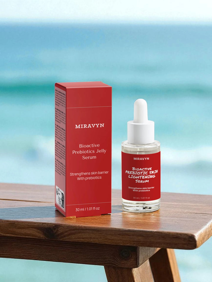 Miravyn bioactive skin lightening serum bottle and box on a wooden table with a blurred ocean background.
