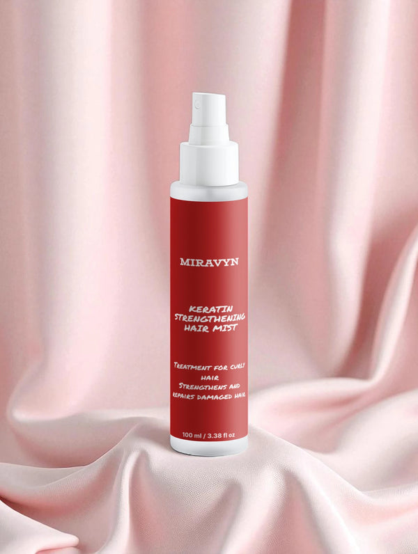 Miravyn strengthening hair mist  on a pink fabric background.