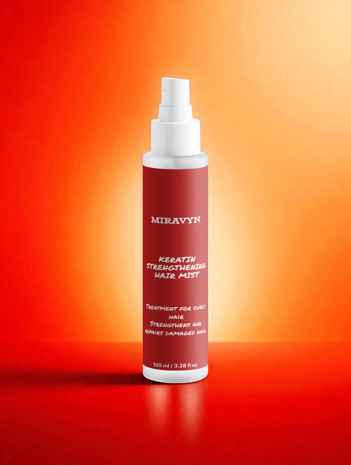 Miravyn strengthening hair mist bottle on a gradient orange background.