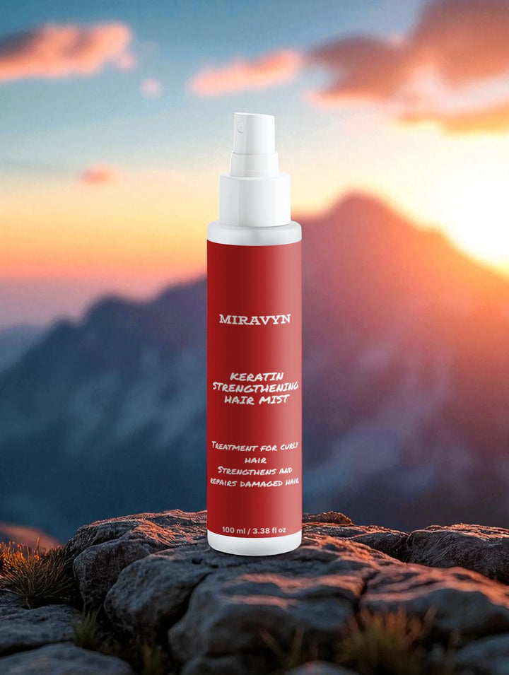 Miravyn  strengthening hair mist on a rocky surface with a mountainous background.