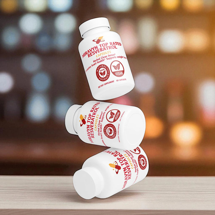 Three bottles of Miravyn Top Rated resveratrol on a wooden surface with a bokeh effect.