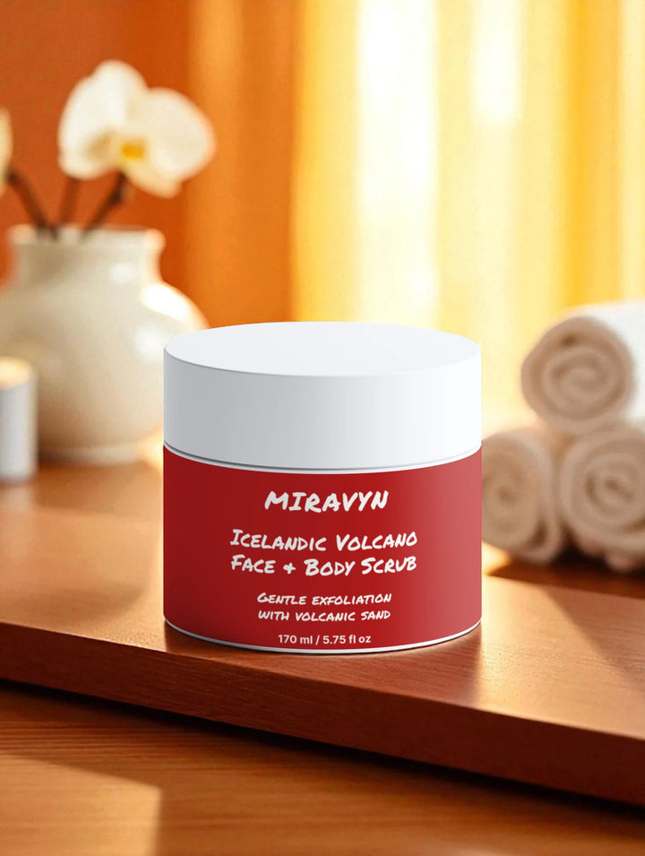 Jar of Miravyn Volcano Face Exfoliator & Body Scrub on a wooden surface with a blurred background.